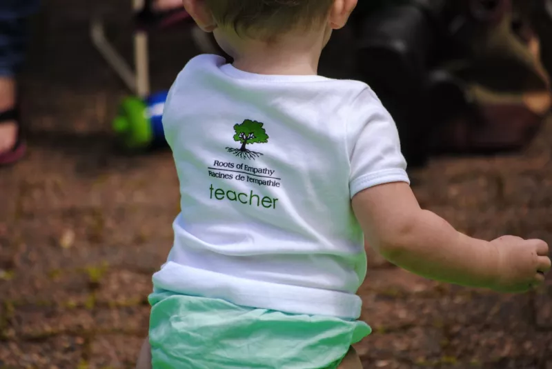 Baby wearing Roots of Empathy tshirt